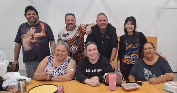 Seven people smiling in a group photo.