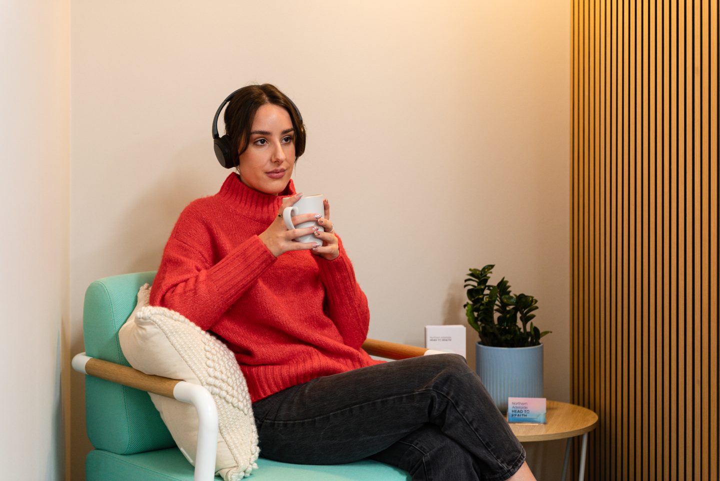 A person relaxes on a chair wearing headphones at Northern Adelaide Medicare Mental Health Centre in Elizabeth.