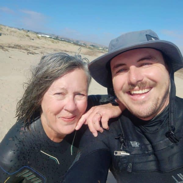 Sue and Matthew, two participants in the SMART Recovery program, smiling together on a beach.